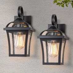 two light fixtures mounted on the side of a wall