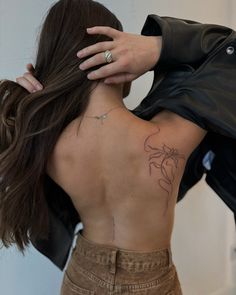 a woman with a tattoo on her back