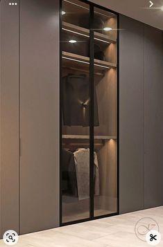 an image of a walk in closet with glass doors