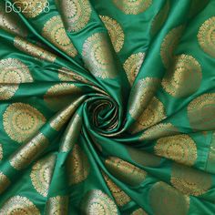 Sea Green Brocade Fabric by the Yard Indian Wedding Dresses Varanasi Silk Crafting Sewing Costume Lehenga Valances Drapery Blouses Upholstery. This is a beautiful pure banarasi brocade in mandala design fabric in Sea Green and Gold ➤Product: Brocade Fabric ➤Fabric Type: Blended (Viscose + Rayon) Fine Quality Zari Brocade Weaving from Banaras ➤Color: Base color is Sea Green and Gold. ➤Width: 42 Inches ➤Condition: New  ➤Code: bg2538 ➤Listing for 1 Yard of fabric. ➤Care: Dry Clean Only Super Fine Quality Brocade Weaving from Banaras. During the Mughal period (1556-1707), when brocade was extremely popular with the rich, the great center of brocade weaving were Benares (Vārānasi). You can use this fabric to make Dresses, Tops, Blouses, Jackets, Crafting, Clutches or Evening Bags, Embellish you Green Art Silk Fabric For Wedding, Green Traditional Fabric For Wedding, Green Traditional Drape Fabric For Wedding, Green Embroidered Fabric For Wedding, Green Wedding Fabric In Traditional Drape, Green Wedding Fabric With Pallu, Traditional Green Wedding Fabric, Green Wedding Fabric For Traditional Drape, Green Fabric For Festive Wedding Occasions