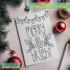 a merry and bright christmas card with ornaments around it on top of a white table