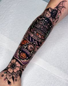 a person with a tattoo on their arm that has an image of a castle and bats