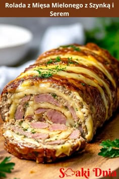 a meatloaf roll is cut into slices on a cutting board with parsley