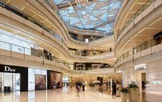 the inside of a shopping mall with people walking around