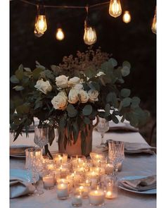 an arrangement of flowers and candles on a table with the cover of inside inspired magazine