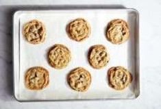 twelve cookies on a baking sheet ready to be baked in the oven or used as an appetizer