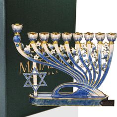 a hanukkah menorah is displayed in front of a green box