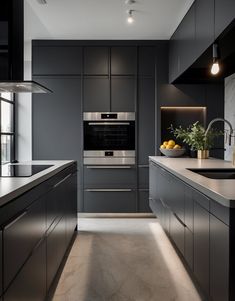 a modern kitchen with stainless steel appliances and marble counter tops, along with black cabinets