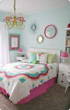 a bedroom with blue walls and pink accents