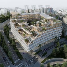 an aerial view of a large building with trees on the roof and balconies