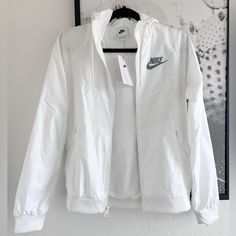 New Nike Windbreaker Zip Up Jacket Size- X-Small Color- White New With Tags No Flaws Fall, Street Wear, Water Proof, Nike, Sportswear Approximate Measurements Laying Flat: Chest- 18.5” Length- 23.5” Comes From Smoke Free Home Same Day/Next Day Shipping *002 Fall Street Wear, White Windbreaker, Nike Windbreaker, Nike White, White Jacket, Zip Up Jacket, Flat Chest, New Nike, Water Proof