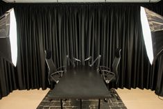 an empty conference room with black drapes