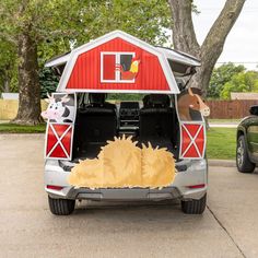 an open hatchback car with the back door open and animals on it's side