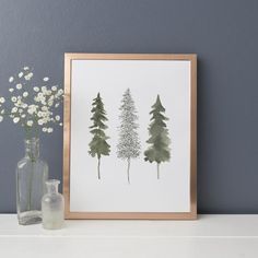 three pine trees are shown in front of a vase with baby's breath flowers