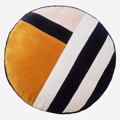 a round cushion with black, yellow and white stripes