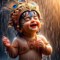 a baby is laughing in the rain while wearing a headdress and holding an umbrella