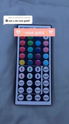 a close up of a remote control on a bed with the words rose gold above it