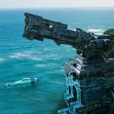 an aerial view of the ocean with a boat in the water and some structures floating on top of it