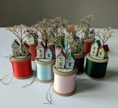 several spools of thread with houses on them