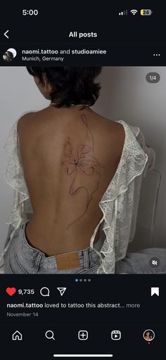 the back of a woman's body with tattoos on her upper and lower back