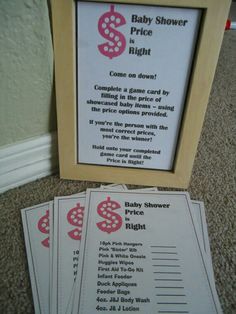 two baby shower game cards next to a wooden frame on the floor in front of a wall