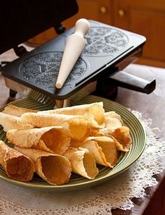 some food is on a green plate with a white doily and a spatula