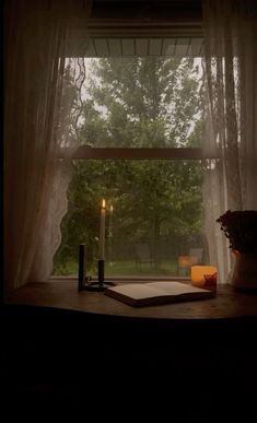 a candle is lit in front of a window