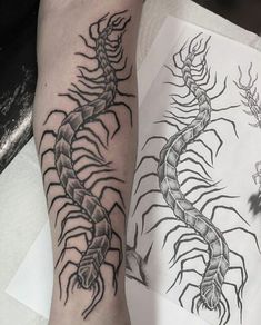 two black and white tattoos on both legs, one with a scorpion tattoo on it