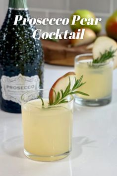 two glasses filled with liquid and garnished with rosemary