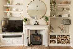 a living room filled with furniture and a fire place in front of a flat screen tv