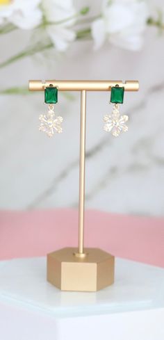 The Emerald Green CZ With Fancy Cut Clear Flower Fashion Earrings feature vibrant emerald green cubic zirconia at their heart, surrounded by intricately cut clear CZ petals in a captivating floral design. These stunning earrings blend the allure of precious gemstones with the finesse of floral motifs, offering a luxurious and eye-catching accessory for any special occasion. Length: 1.15 inches Width: 0.57 inches Closure: Butterfly Backs Material: Brass with 18K Gold Plating with Rhodium Coating Elegant Emerald Crystal Earrings For Party, Elegant Green Clip-on Earrings For Wedding, Emerald Flower Earrings, Green Flower-shaped Party Earrings, Luxury Green Clip-on Earrings For Evening, Cz Diamond, Stunning Earrings, Christmas Sale, Precious Gemstones