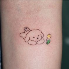 a small dog with a flower in its mouth tattoo on the left side of the arm