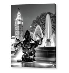 a black and white photo of a fountain with a horse statue in the foreground