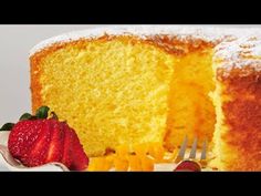 a piece of cake on a plate with a fork and strawberries next to it