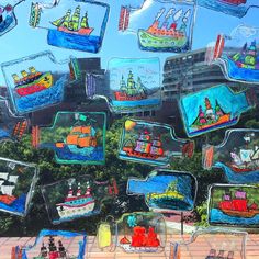 an image of many different colored boats in the sky and on display behind glass windows