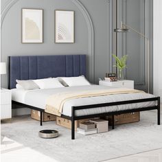 a bed that is sitting in the middle of a room with a blue headboard and foot board