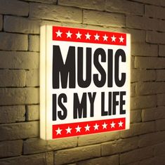 there is a sign that says music is my life on the side of a brick wall