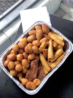 a tin pan filled with fried food on top of a table