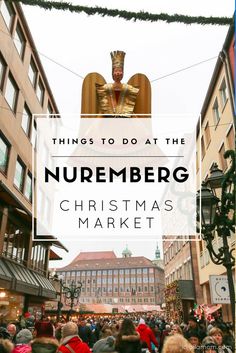 a crowd of people walking down a street next to tall buildings with the words, things to do at the nuremberg christmas market