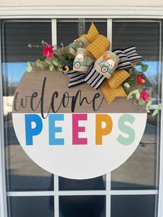 a welcome pees sign hanging on the side of a door