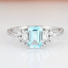 Gorgeous emerald cut aquamarine ring is made of 925 solid sterling silver, making a simple but elegant statement piece. This ring is perfect to wear as engagement ring, promise ring, birthstone ring, or statement ring. Hypoallergenic, lightweight and minimalist. Main Stone: Aquamarine Shape: Emerald Gem size: 5 x 7 mm Carat Weight: 1.3 ct. (approx.) Stone Creation: Lab-Created Hardness: 8 (Mohs scale) ►Your sterling silver ring will not turn green itself and will not cause your skin to turn gree Emerald Cut Aquamarine Ring, Ring Emerald Cut, Aquamarine Engagement Ring, Ring Emerald, Aquamarine Ring, March Birthstone, Aquamarine Rings, 14k White Gold Ring, Natural Aquamarine