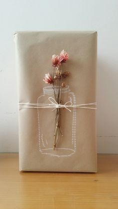 a wrapped gift with flowers tied to it