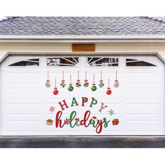 a garage door with the words happy holidays written on it and decorations hanging from the side