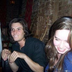 three people sitting at a table with drinks