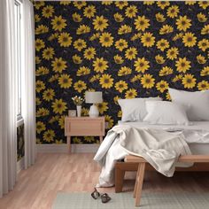 a bedroom with sunflowers on the wall and bedding in front of it