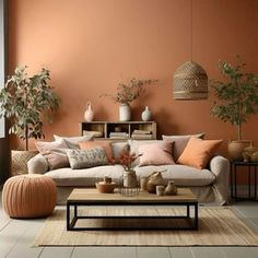 a living room filled with lots of furniture next to a wall painted in orange and white