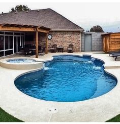 a backyard with a pool and hot tub