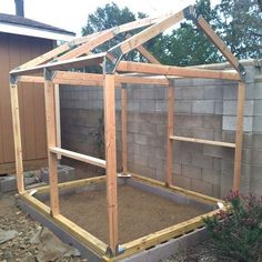 a small house built into the side of a brick building with wooden framing and roof