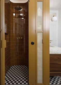 an open door leading to a bathroom with black and white checkerboard flooring