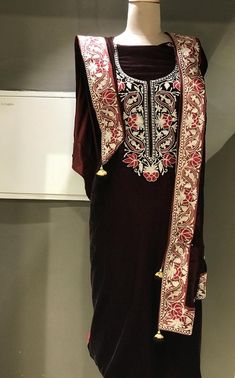 A stunningly marvellous velvet dress. This suit features intricate zari/tilla embroidery on the shirt neck, on sleeves and 4 sided embroidered border on the dupatta.- - - - - - - - - - - - - - - - - - - - Product Details- Condition Brand New - Dupatta Size: 88" X 38" (225 cms X 96.52 cms) approx.- Colour: MarronF A B R I CShirt: VelvetDupatta: VelvetBottom: Velvet or Indian Crepe (whichever you prefer, let us know.)F I N I S HUnstitched/Semi-StitchedYou can get it stitched locally.47+ inches of Traditional Velvet Salwar Kameez With Straight Kurta, Traditional Velvet Straight Kurta, Velvet Kurta With Resham Embroidery For Festivals, Velvet Resham Embroidery Kurta For Festivals, Festival Velvet Kurta With Resham Embroidery, Straight Velvet Kurta For Festivals, Velvet Straight Kurta For Festivals, Festival Velvet Straight Kurta, Velvet Party Dress With Resham Embroidery